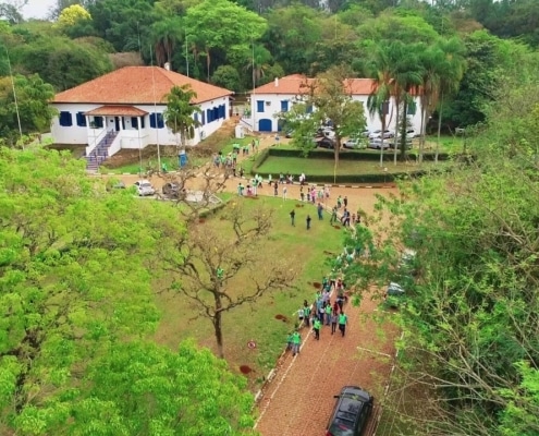 Aerial photo of the Paulinia site with people gathered outside.